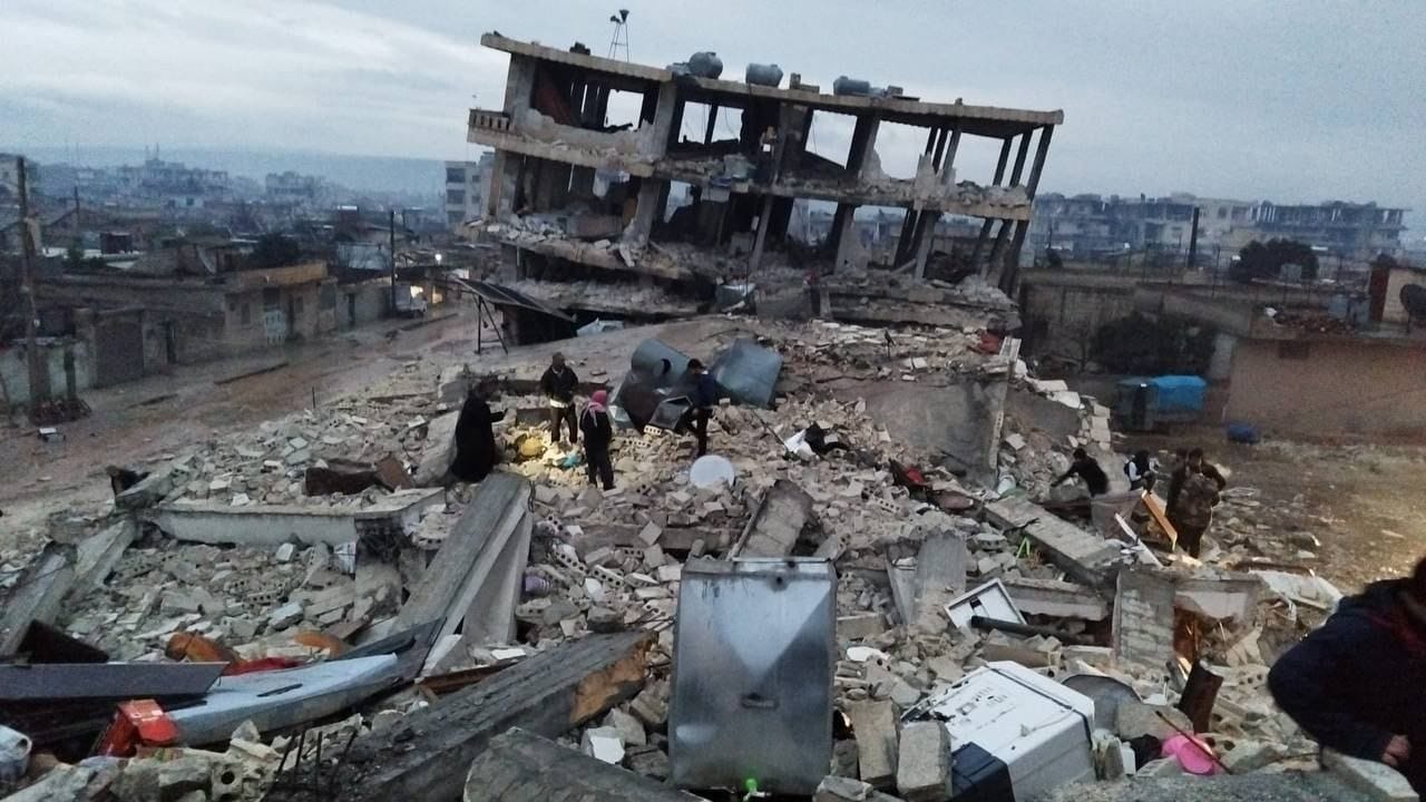 Buildings toppling and surrounded by rubble