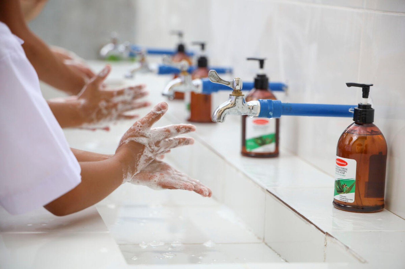 Close up of children's hands as they thoroughly wash them