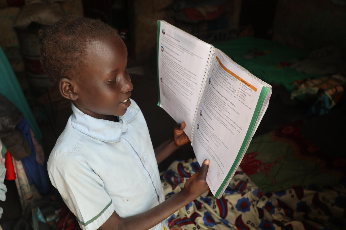 10-year-old South Sudanese girl reads from a school textbook