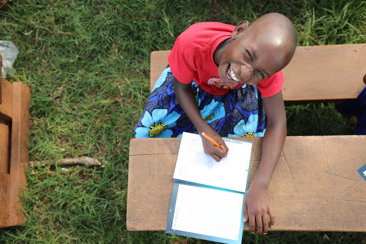 Joane poses with her sponsored child and her family in Uganda