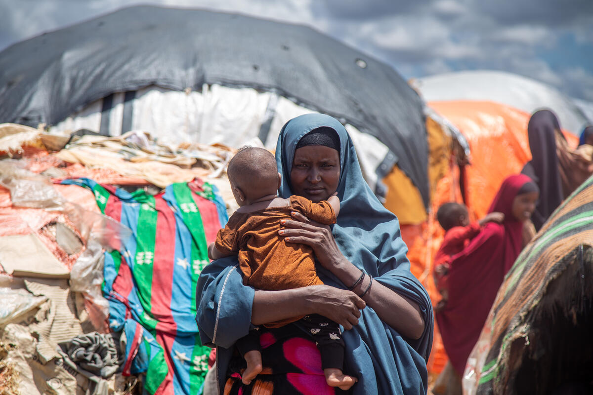 A refugee Somalian woman holds her baby