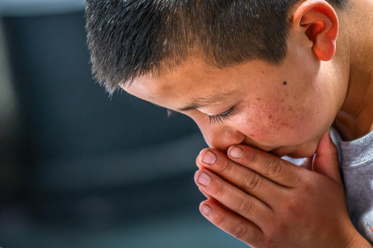 A young boy in Guatemala praying