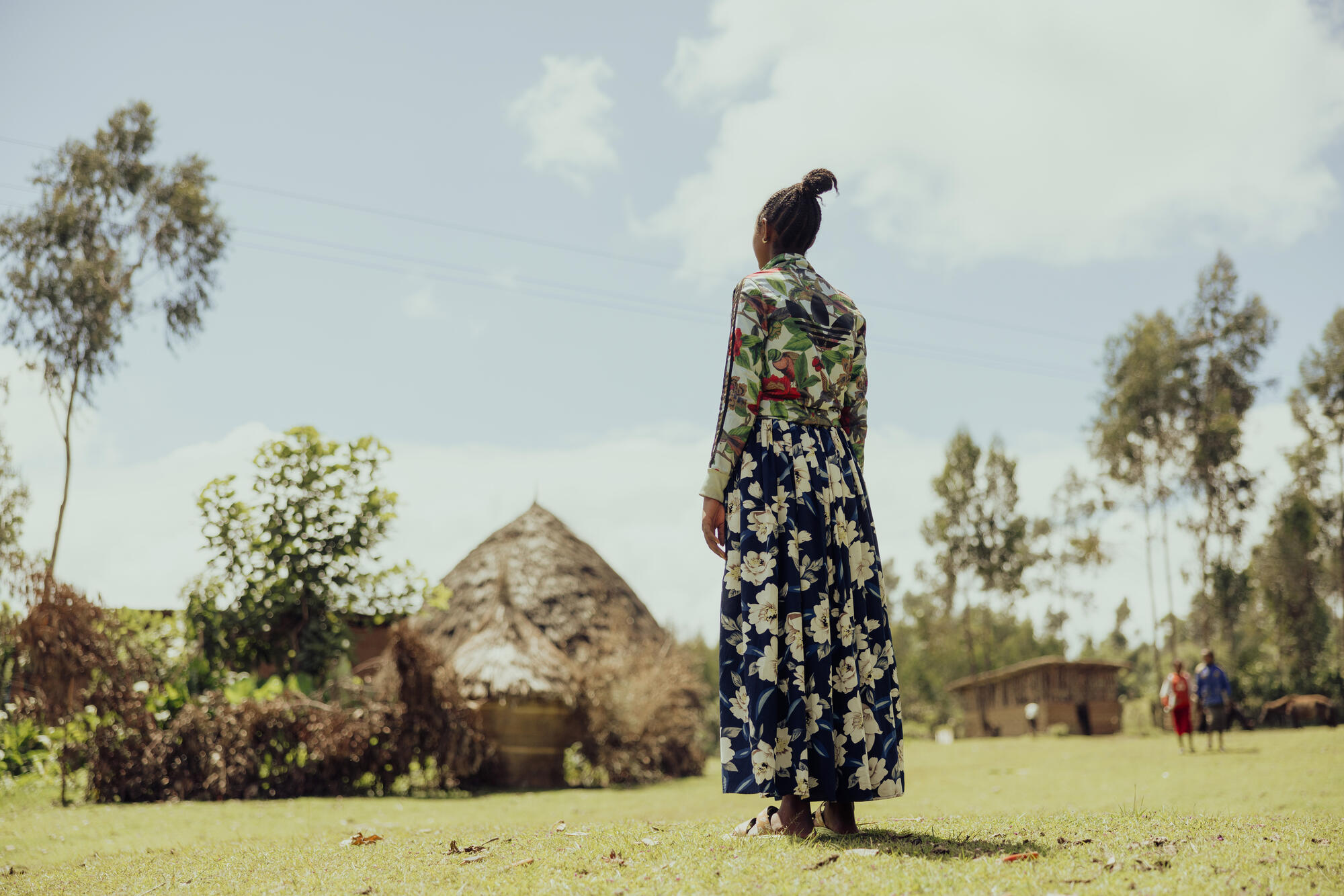 A women facing away, looking out to the distance
