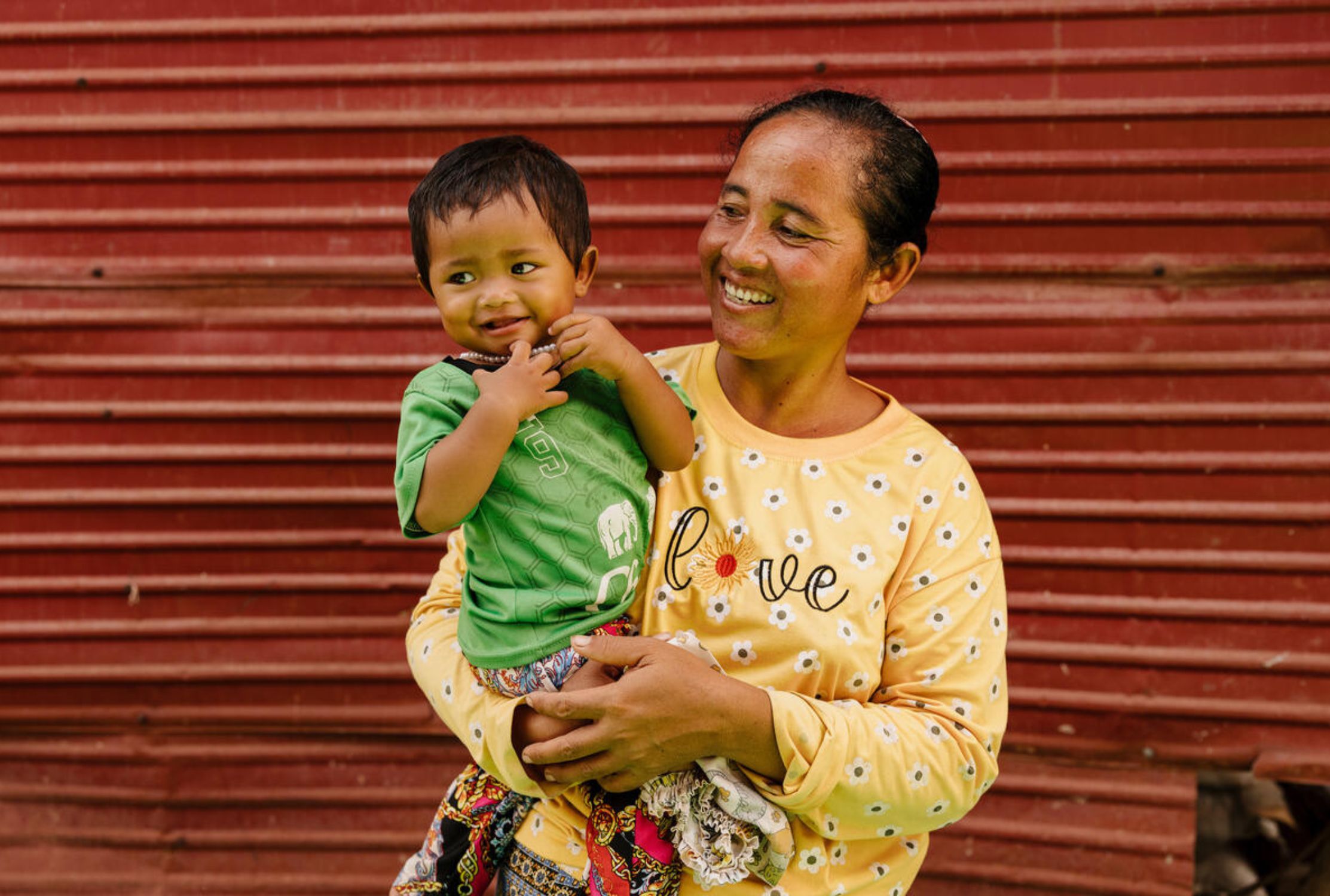 11-month-old girl from Cambodia being held by her mother