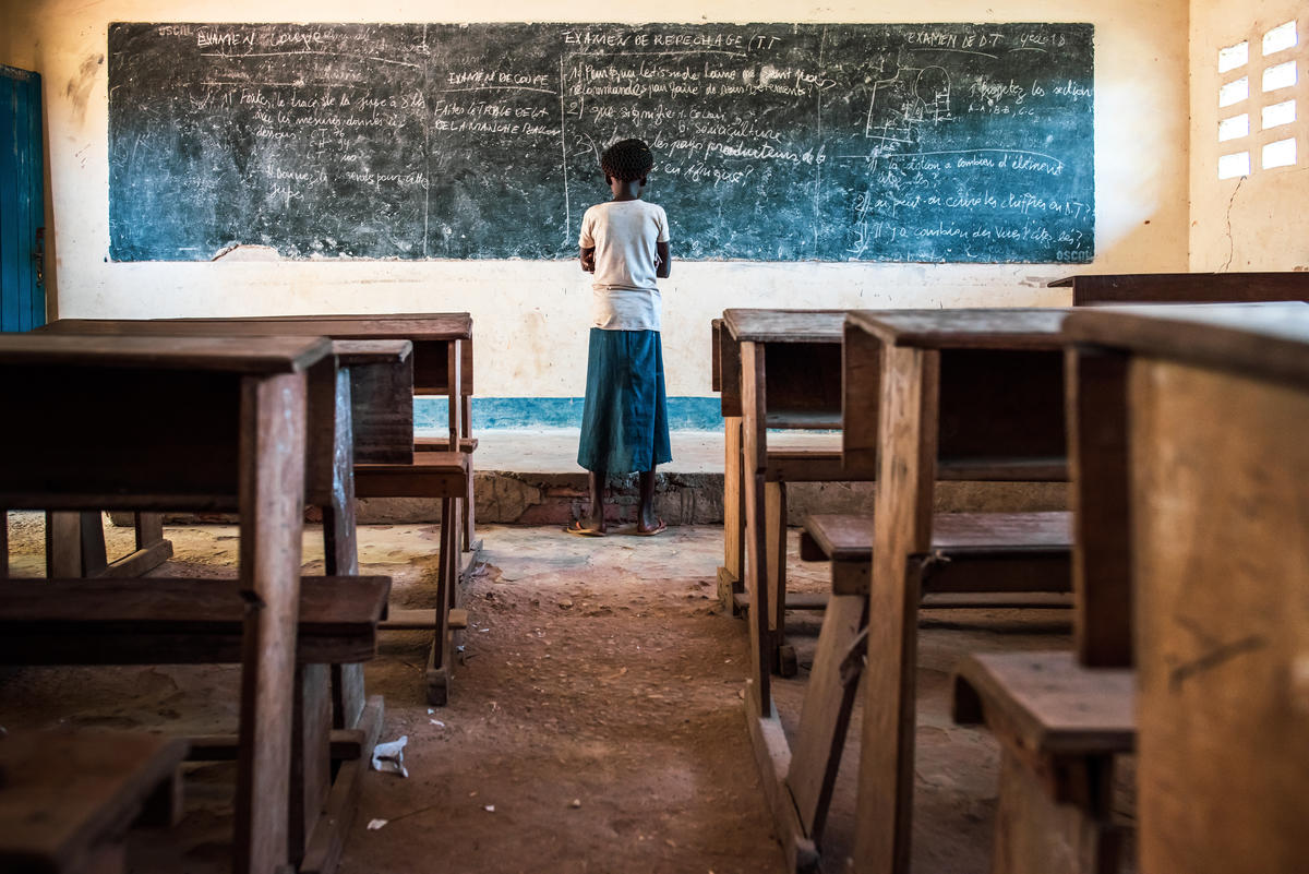 Girl stands in front of a blackboard in DCR
