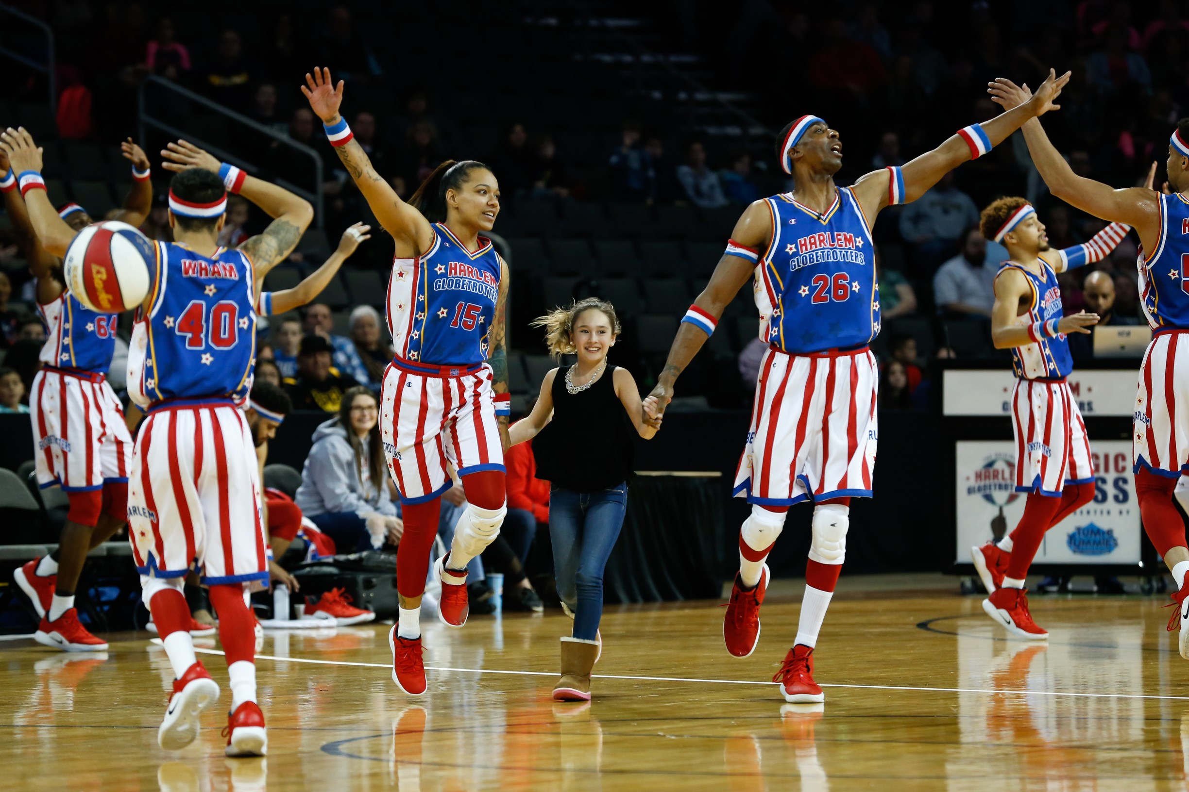Basketball players reach for the ball during a Harlem Globetrotters game
