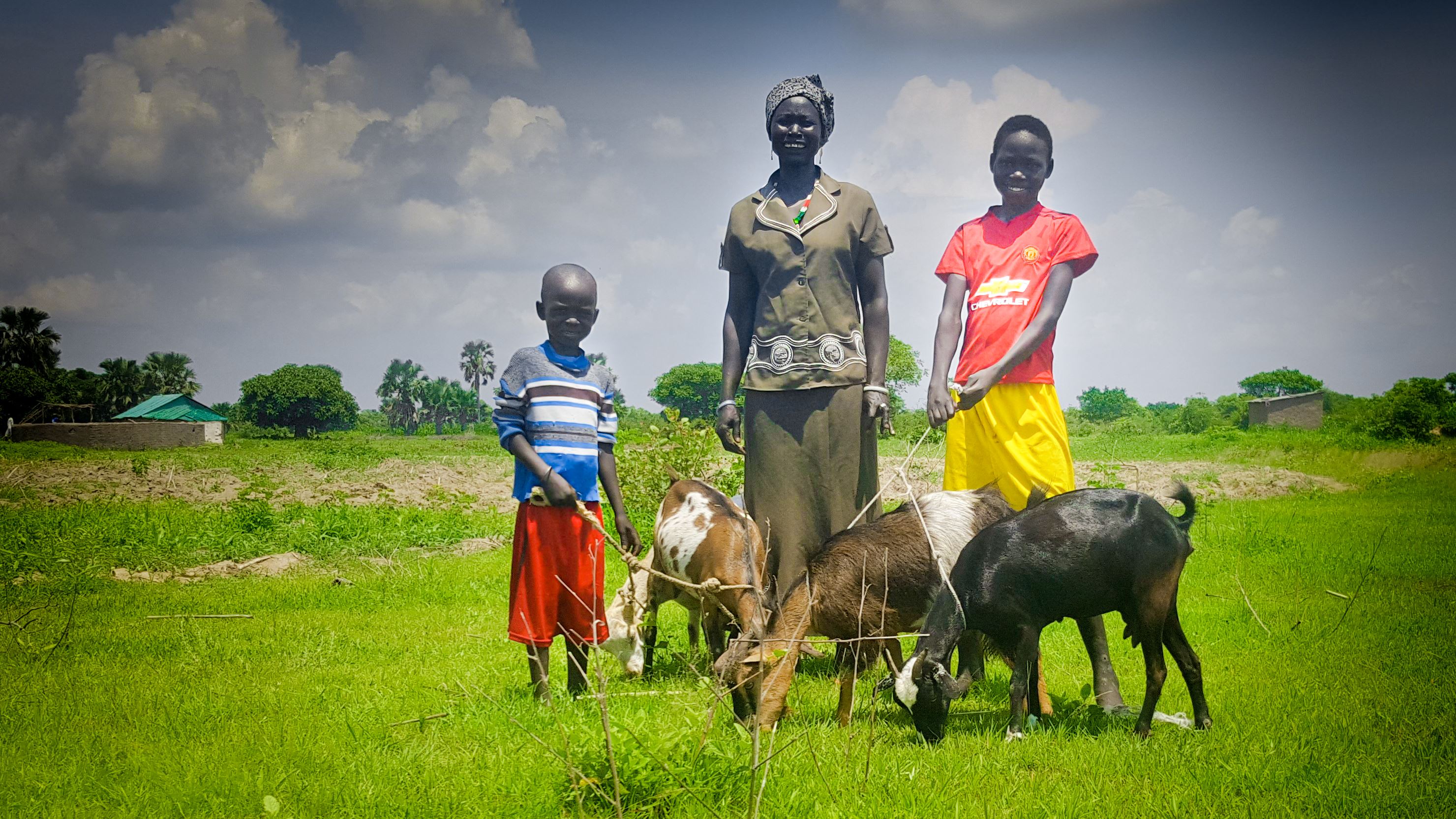 A mother and her two sons with their farm animals in South Sudan