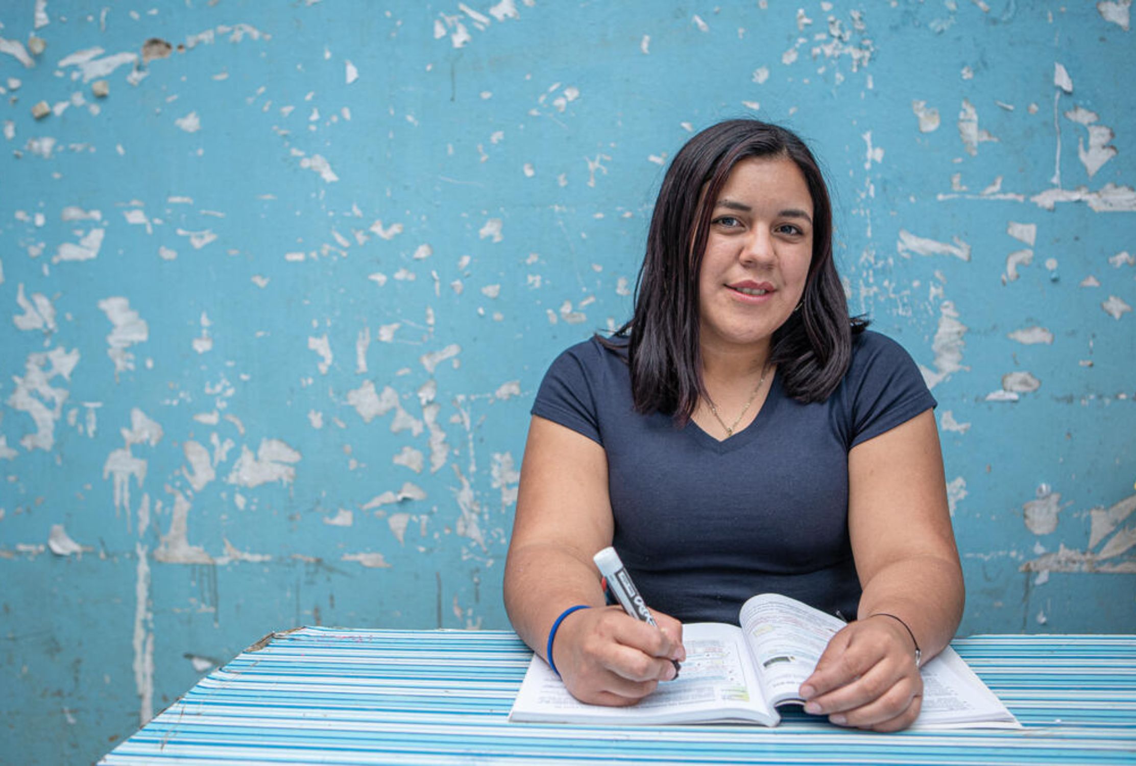 Former sponsored child from Honduras planning a school lesson now she is a teacher