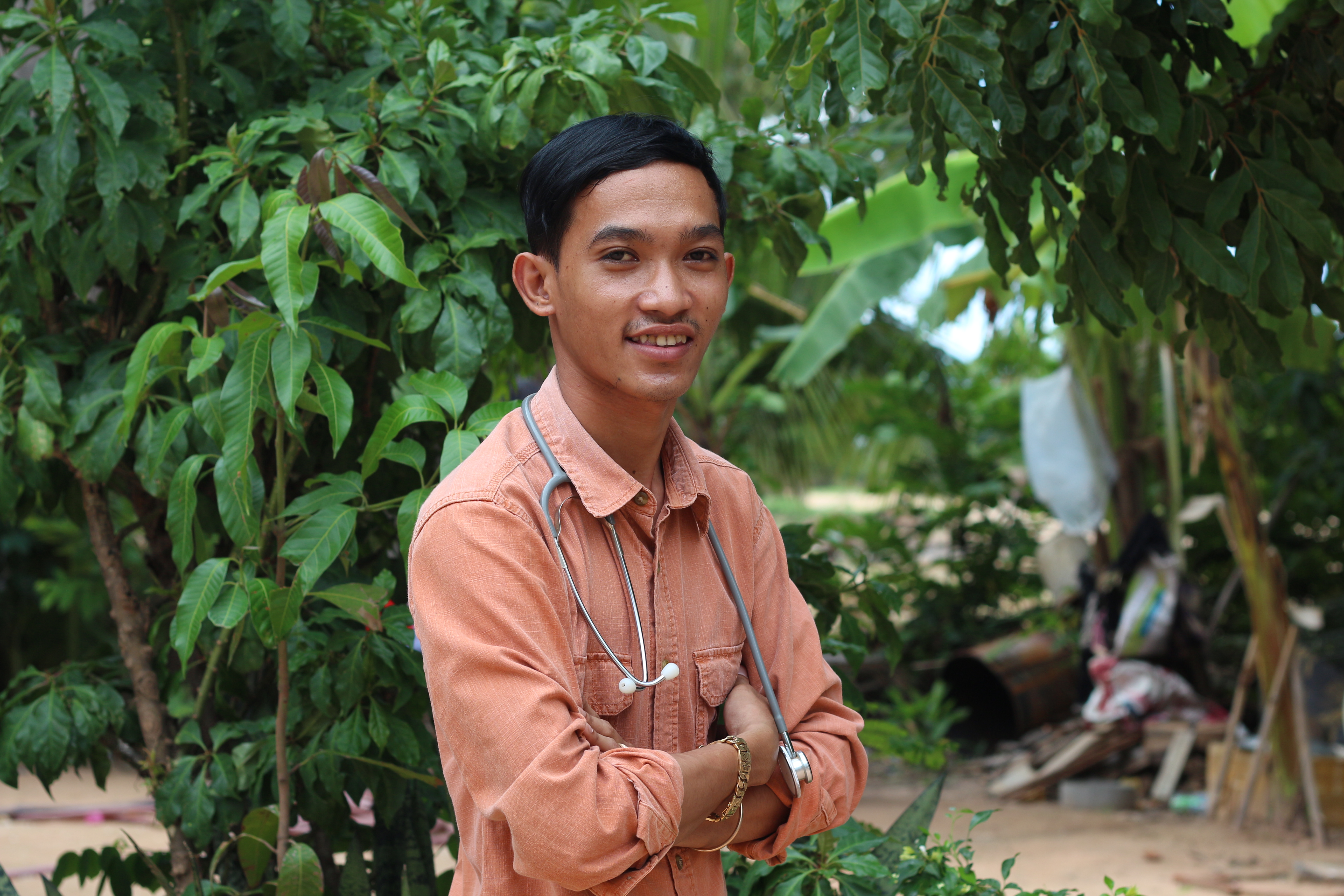 Vathanak poses proudly, his stethoscope round his neck