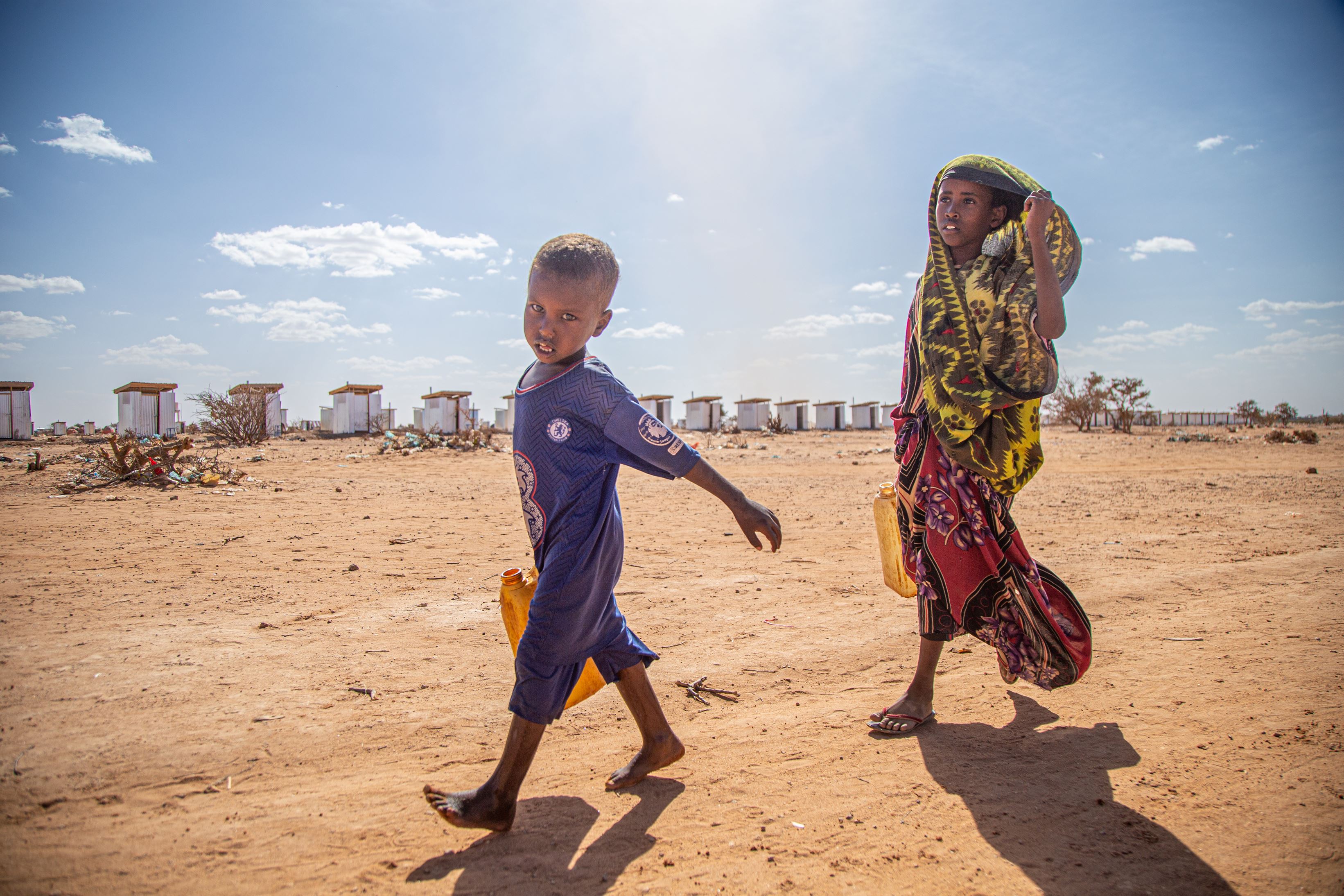 Two children carrying water.