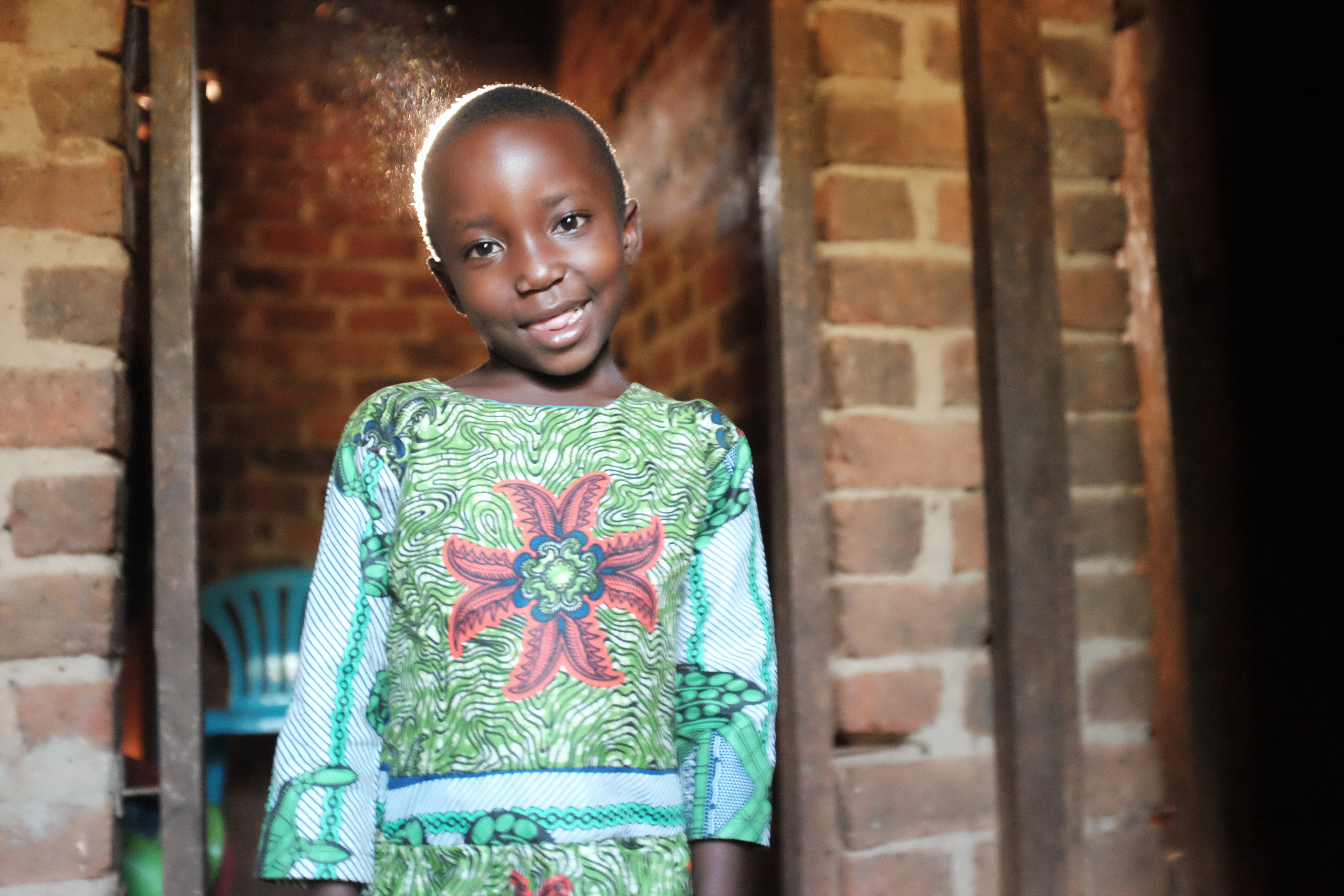 Amina young girl in door way of her home inUganda