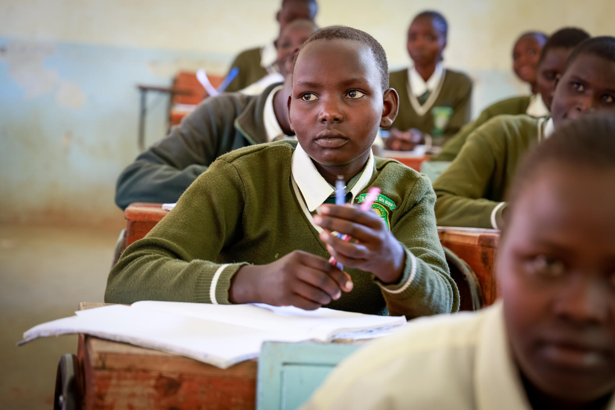 A child sat at desk in a classroom