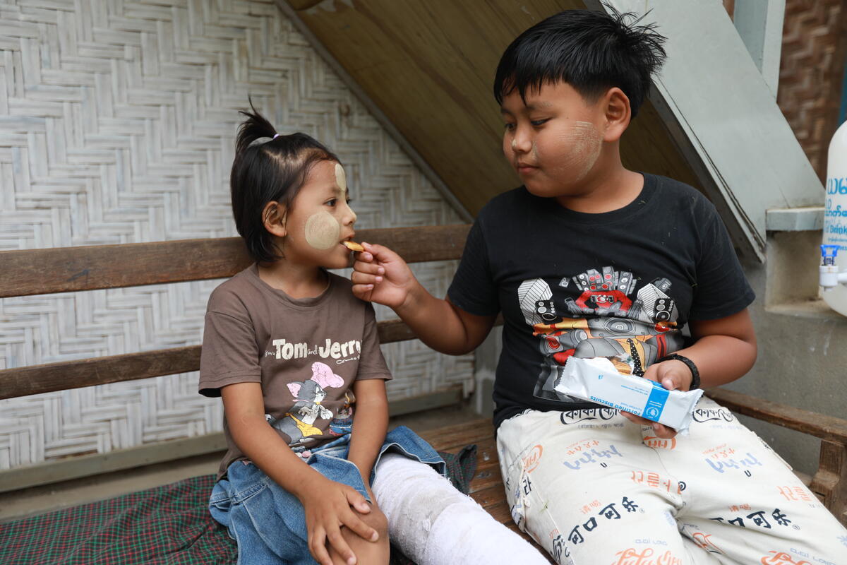 A young boy and a young girl with the food package they received