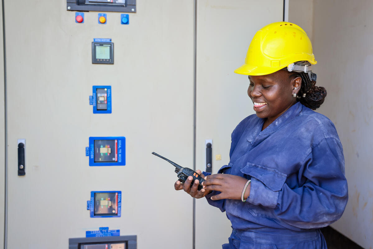 Emily at work, she wears her gear and a yellow helmet