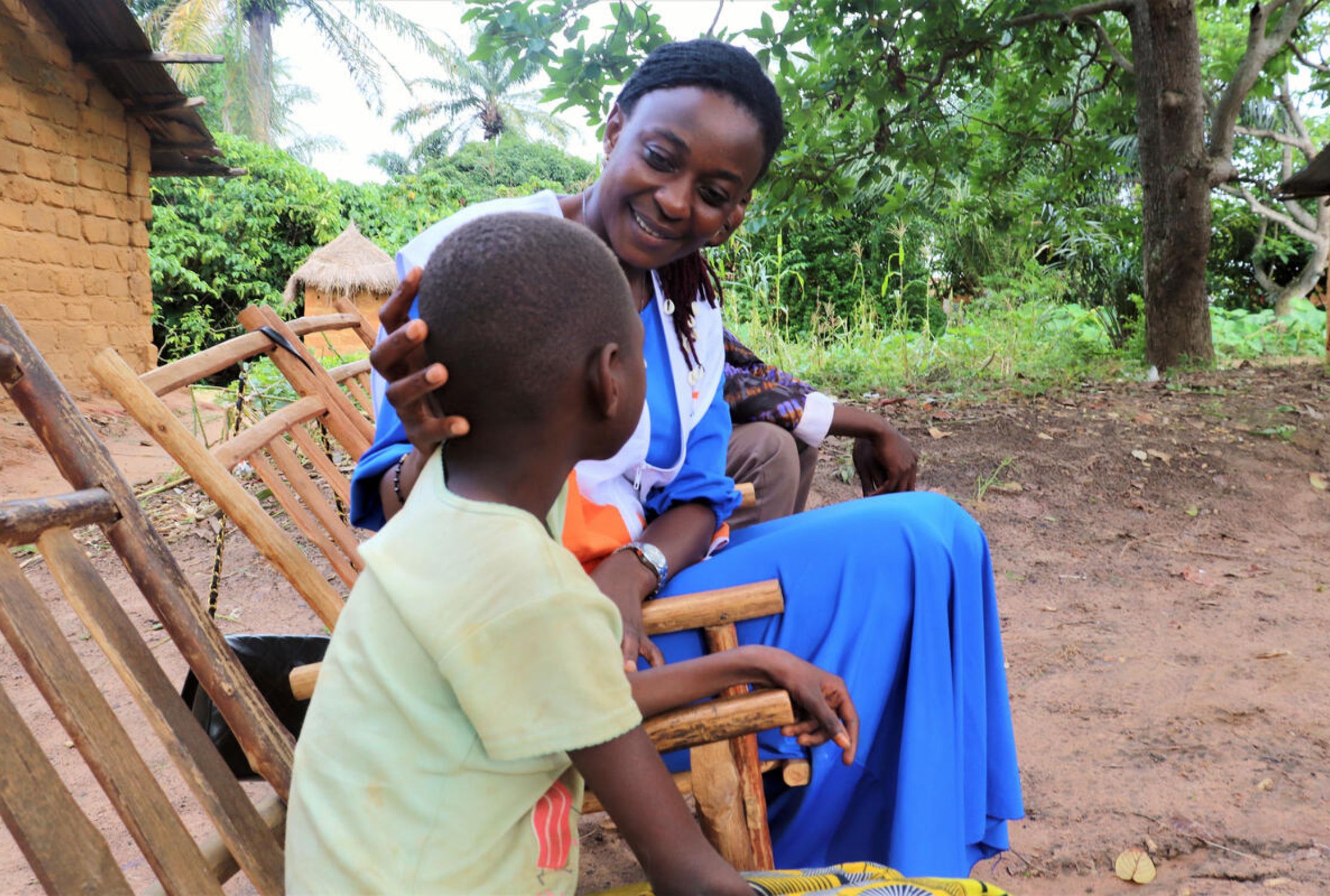 World Vision staff sat with a child in the Democratic Republic of Congo