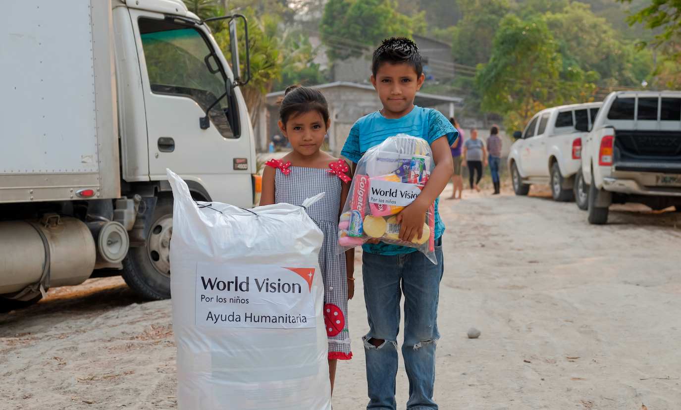 Two children with their coronavirus supplies in bags