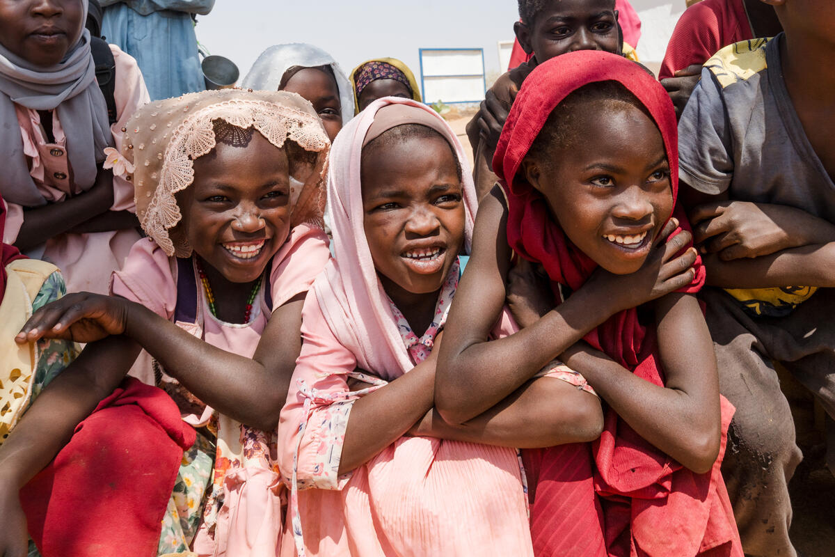 Ukrainian refugee family outside World Vision orange tent