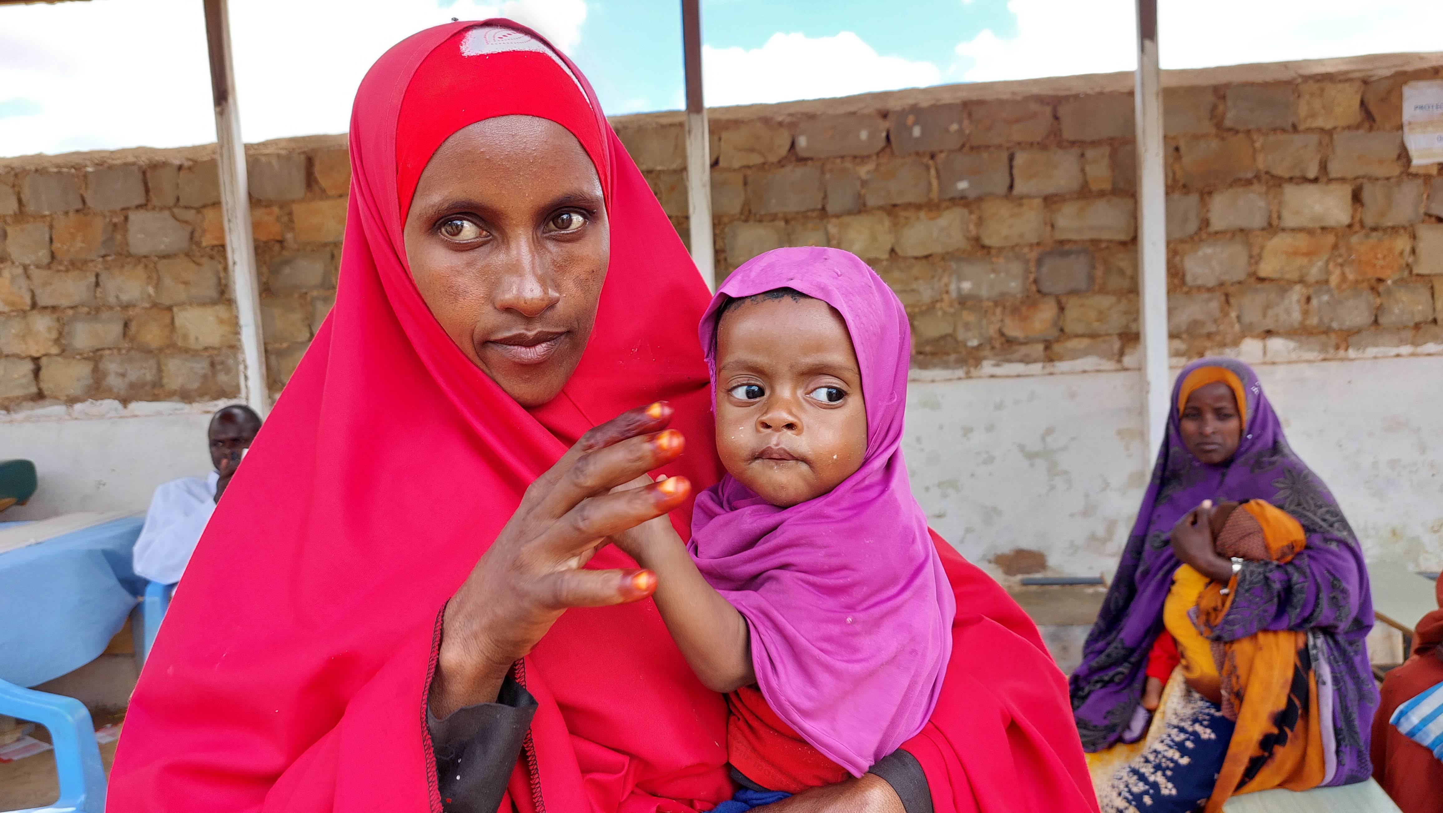 Somali woman holding her young daughter