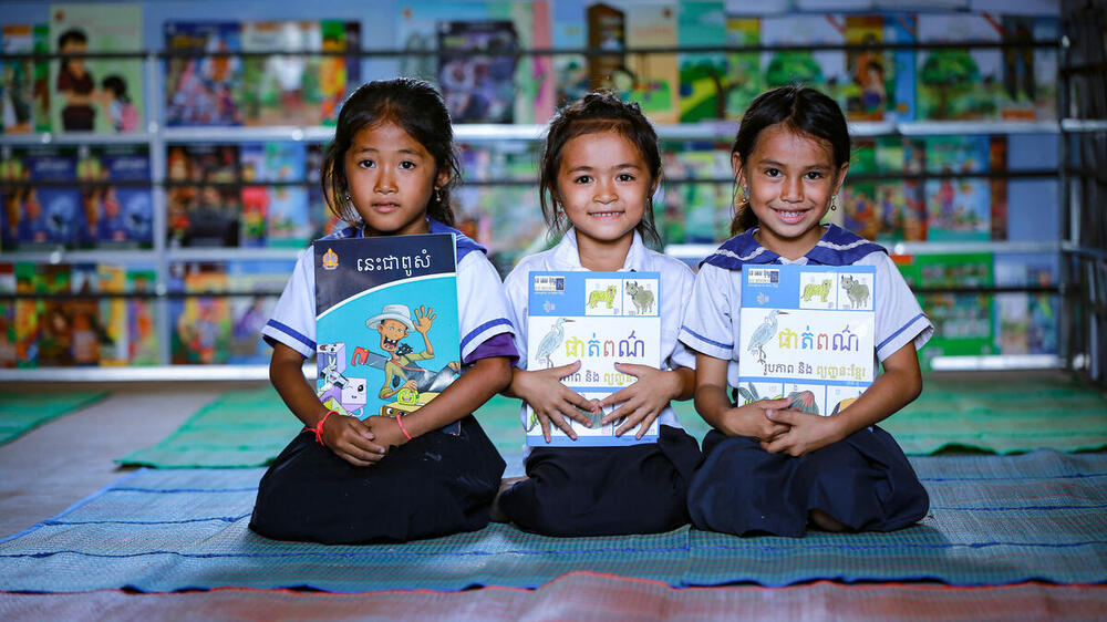 Happy children holding out their new reading books