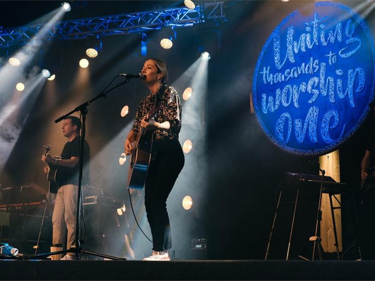 Two musicians on stage at New Wine United