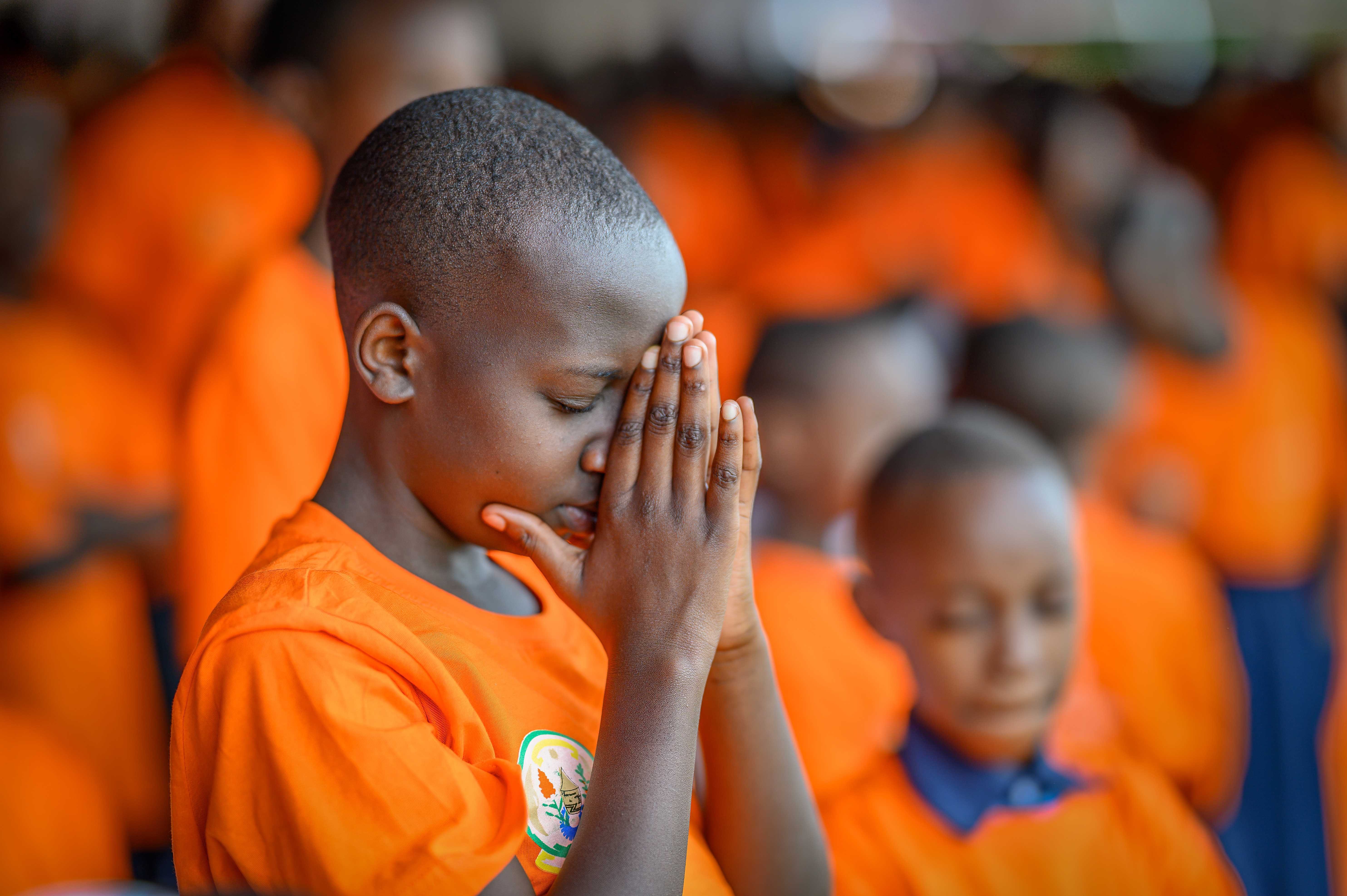 Young boy in Rwanda prays